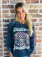 Model wearing the 'OLDIE BUT GOODIE' sweatshirt by Recycled Karma, styled in a casual, chic outfit.