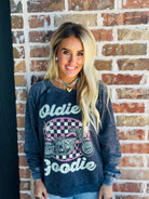 Flat lay of the 'OLDIE BUT GOODIE' sweatshirt by Recycled Karma, emphasizing its worn, washed texture and comfortable fit.