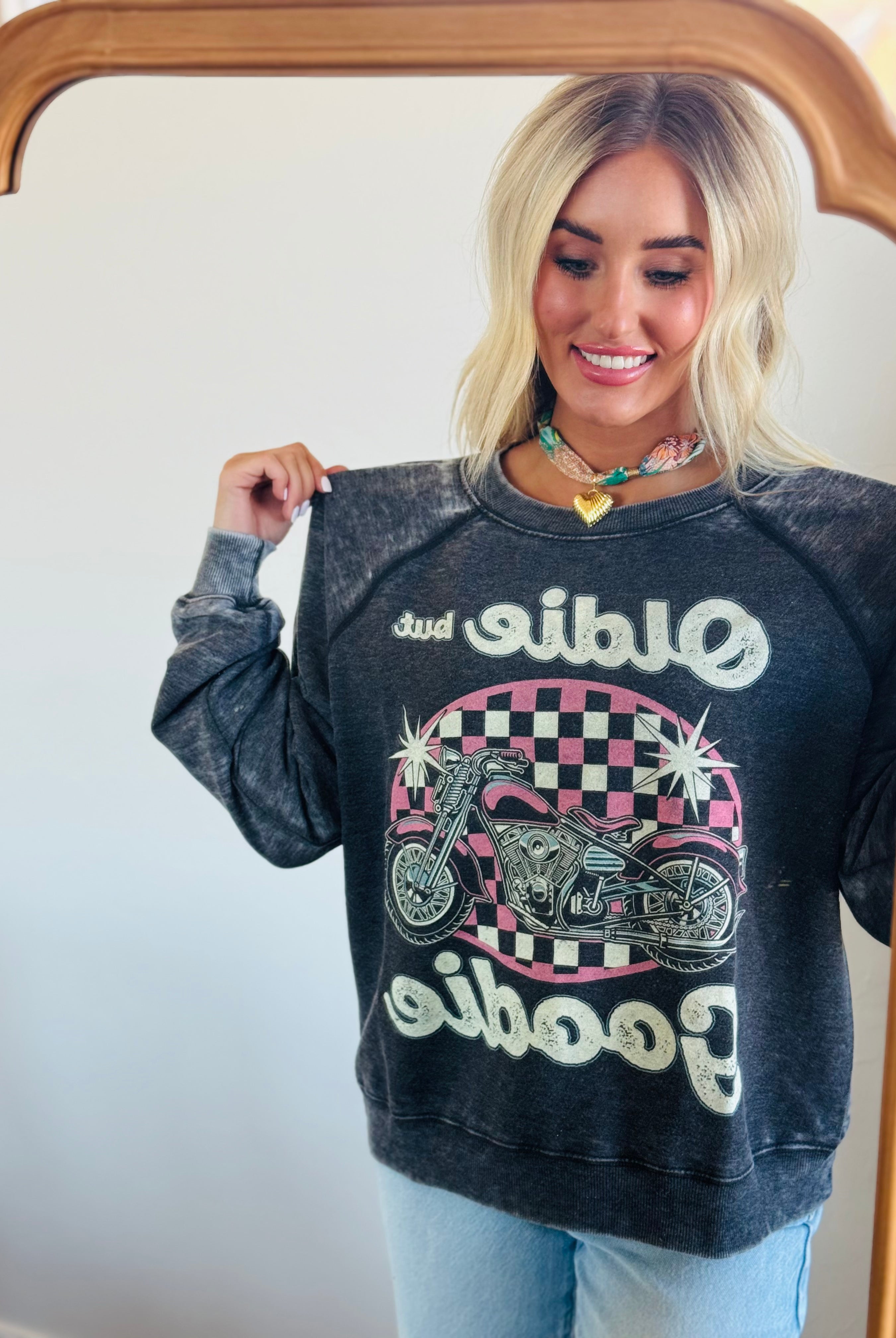 Lifestyle image featuring the 'OLDIE BUT GOODIE' sweatshirt by Recycled Karma, perfect for retro fashion lovers.