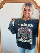 Lifestyle image featuring the 'OLDIE BUT GOODIE' sweatshirt by Recycled Karma, perfect for retro fashion lovers.