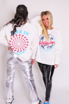 Oversized ivory Rolling Stones vintage concert sweatshirt with ribbed hems and crew neckline, perfect for fans of the legendary rock band.