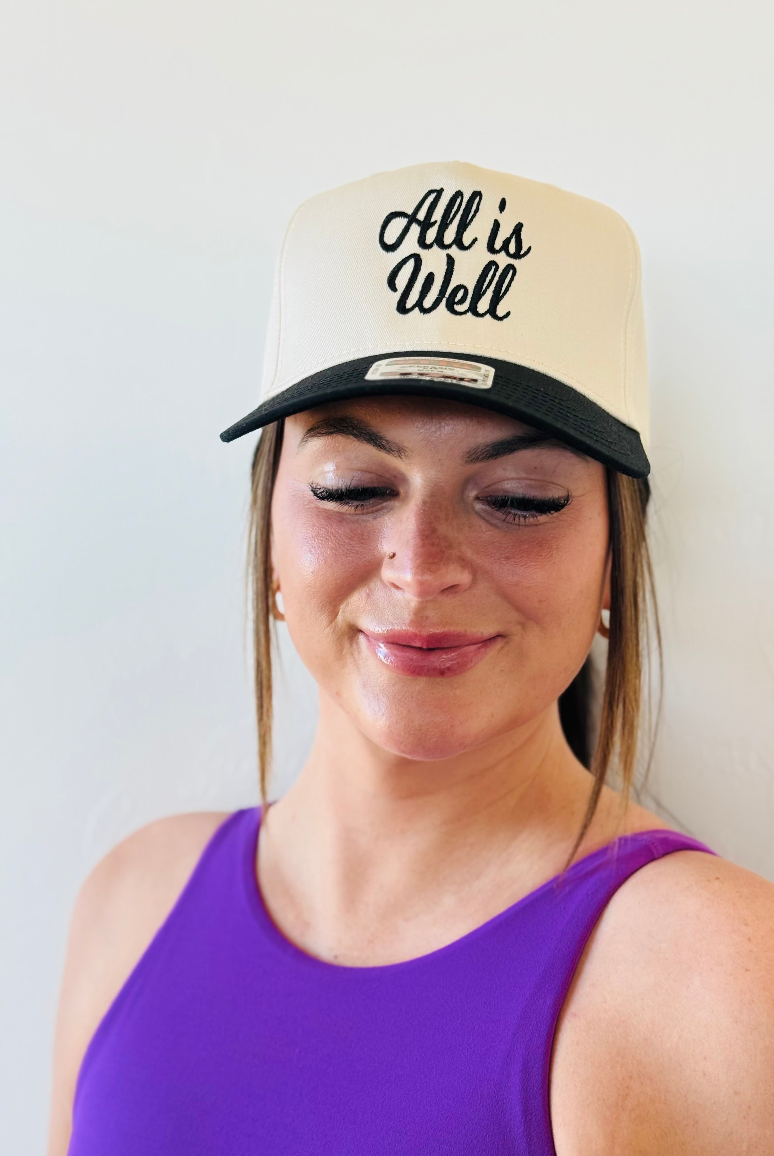 ALL IS WELL EMBROIDERED TRUCKER HAT featuring elegant black embroidery on a natural color background, perfect for stylish comfort in any outfit.