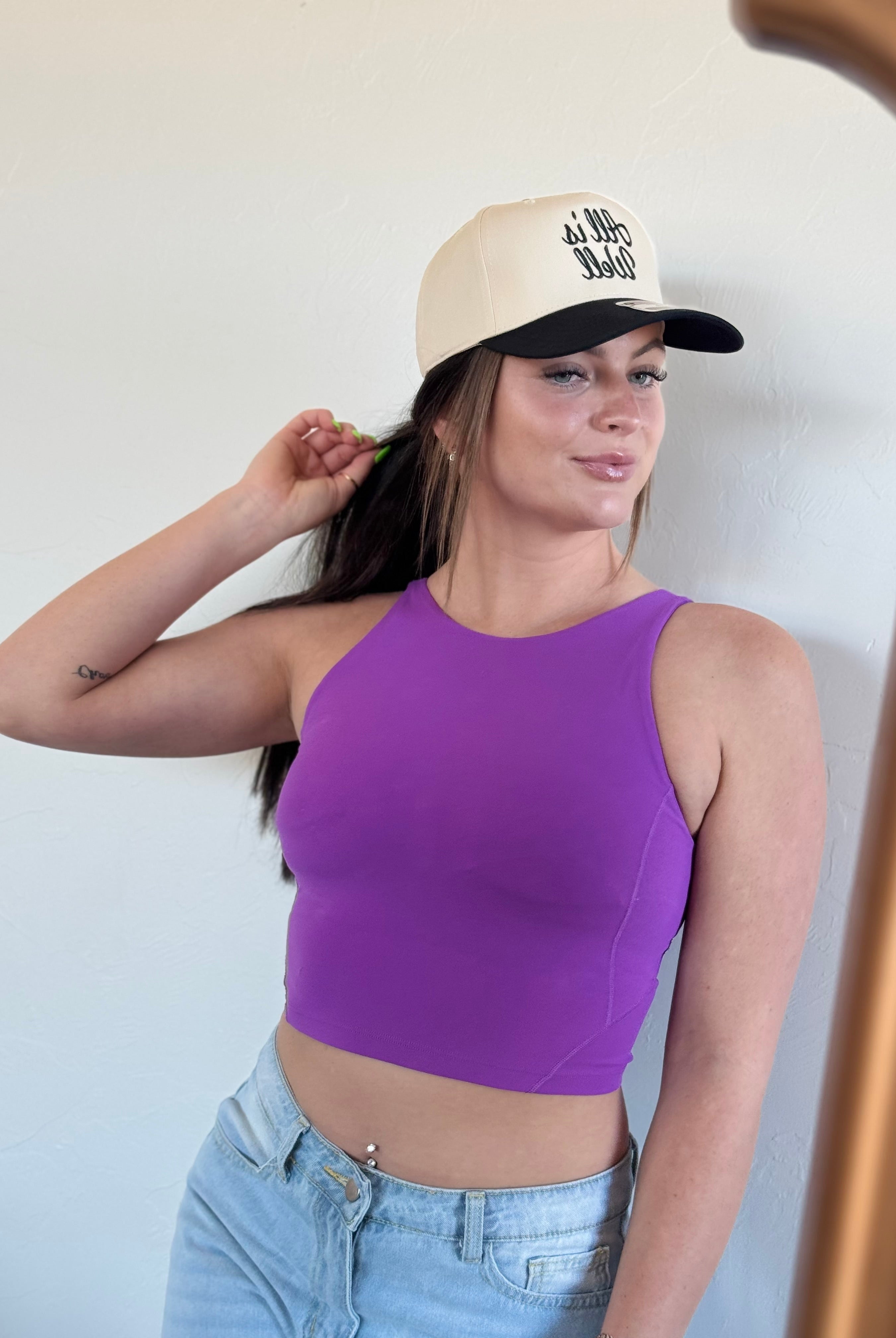 Detailed image of the ALL IS WELL EMBROIDERED TRUCKER HAT emphasizing the bold embroidery and comfortable fit for everyday wear.