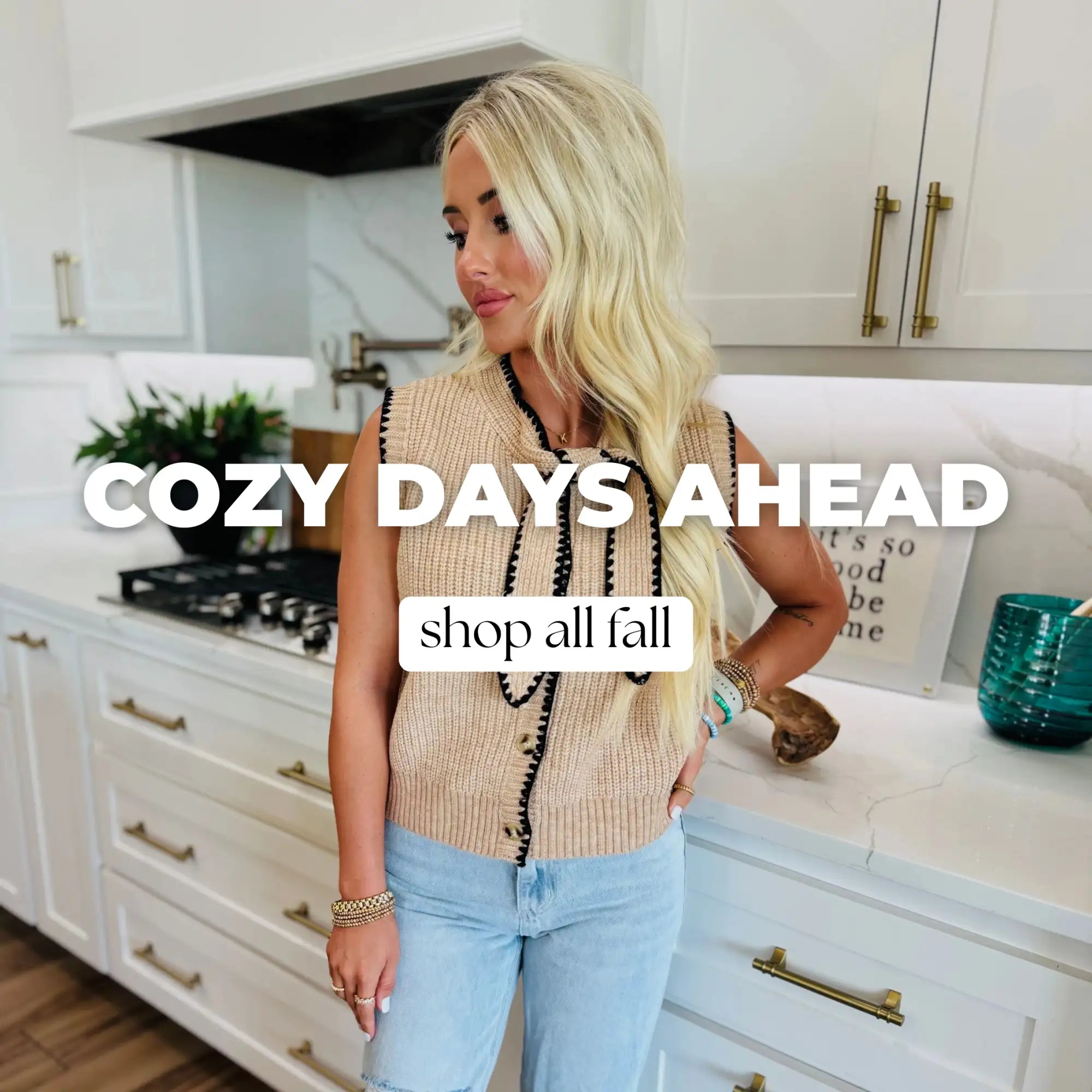 Beige ribbed sleeveless sweater with black beaded trim and gold hardware.