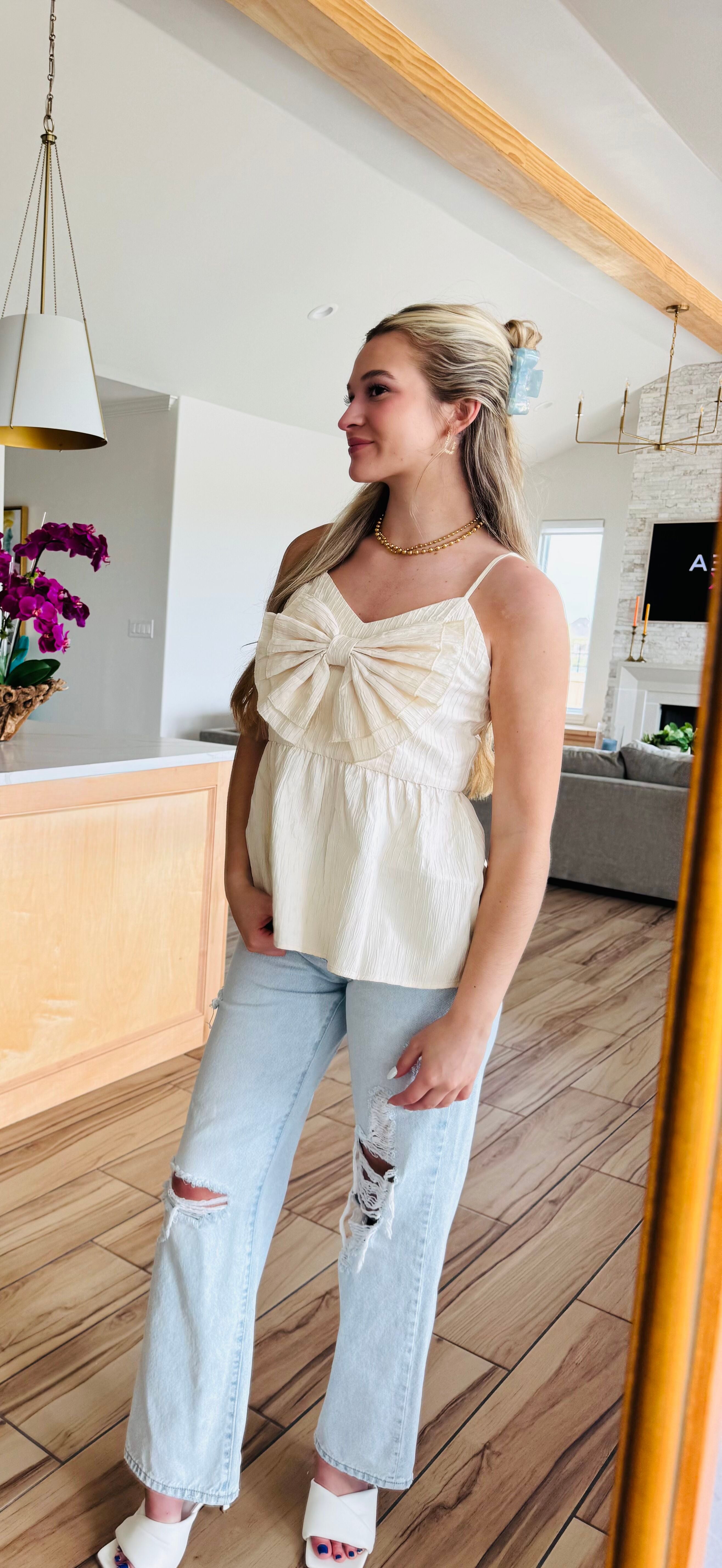 Close-up of the ECRU BABYDOLL TEXTURED BOW TOP, highlighting the quality fabric and beautiful bow detail, perfect for everyday wear.