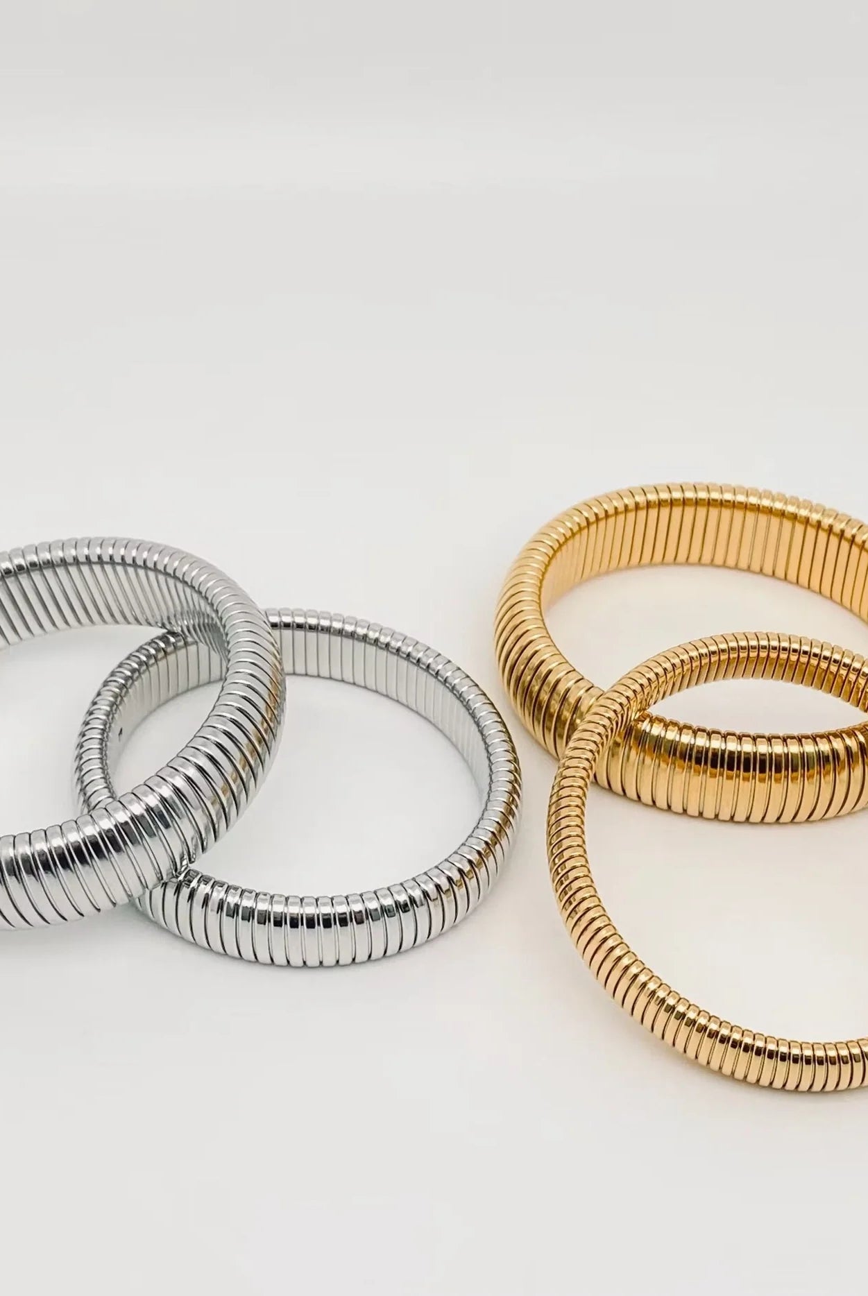 Elegant Elastic Gold Plated Bangle - 10 mm from Aurea Lux Collective, showcasing its stylish design and luxurious gold finish.