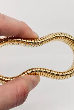 Close-up of the Elastic Gold Plated Bangle - 10 mm, highlighting the durable stainless steel construction and gold plating.