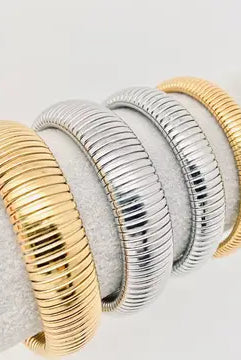 Fashionable Elastic Gold Plated Bangle - 10 mm worn by a model, demonstrating its flexibility and chic appearance in everyday accessorizing.