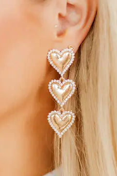 Layla - Gold Heart Earrings showcased in a bright setting, emphasizing their intricate design and sparkly CZ stones.