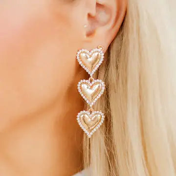 Layla - Gold Heart Earrings showcased in a bright setting, emphasizing their intricate design and sparkly CZ stones.
