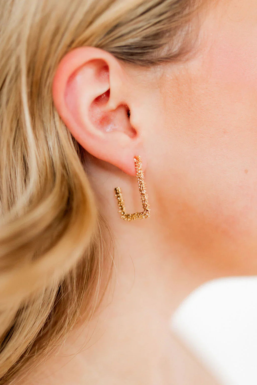 Close-up view of Joy Earrings, 30mm rectangular hoop design by LINNY CO, perfect for adding elegance to any outfit.