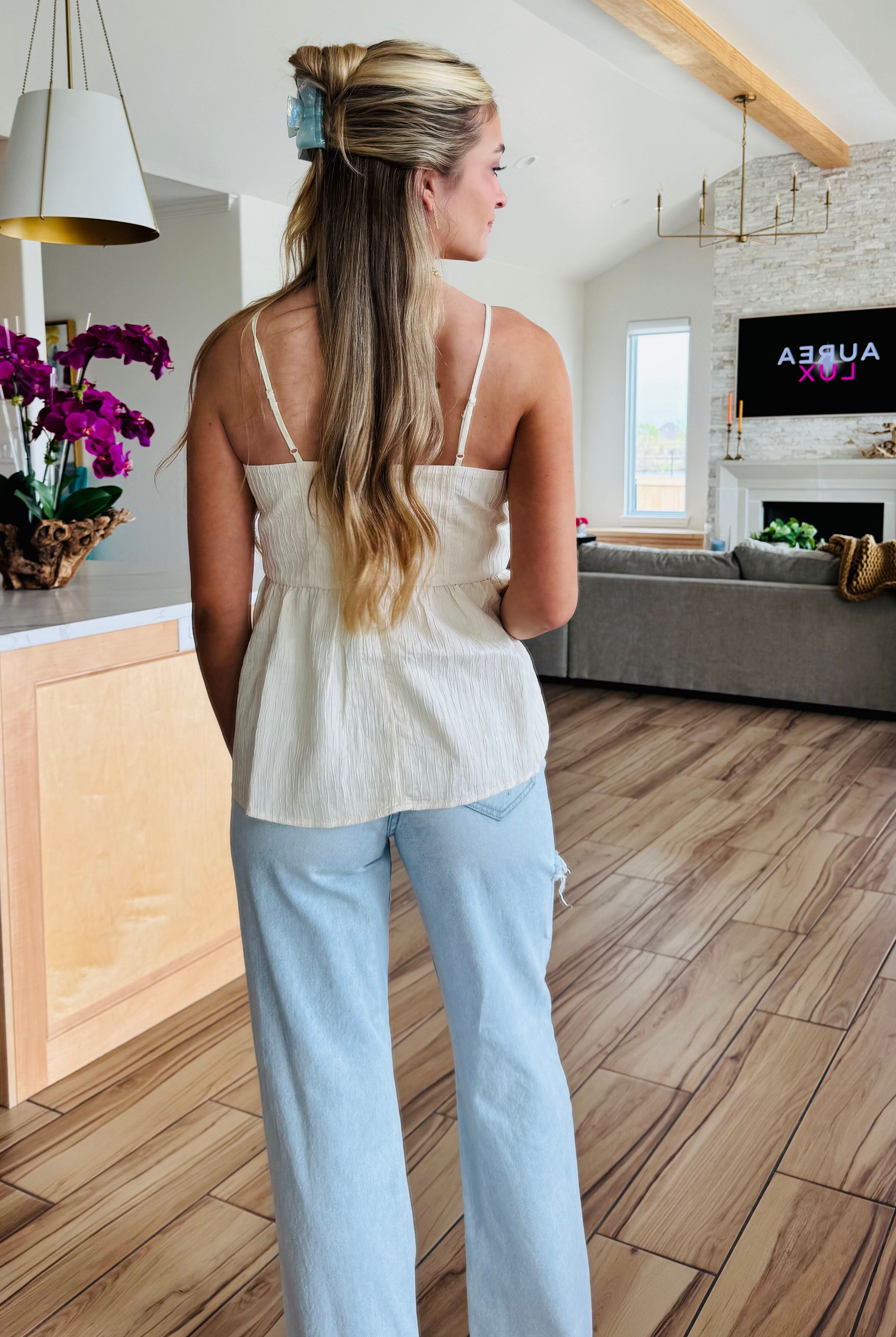 Model wearing ECRU BABYDOLL TEXTURED BOW TOP by Heyson, demonstrating its relaxed fit and versatility, perfect for dressing up or down.