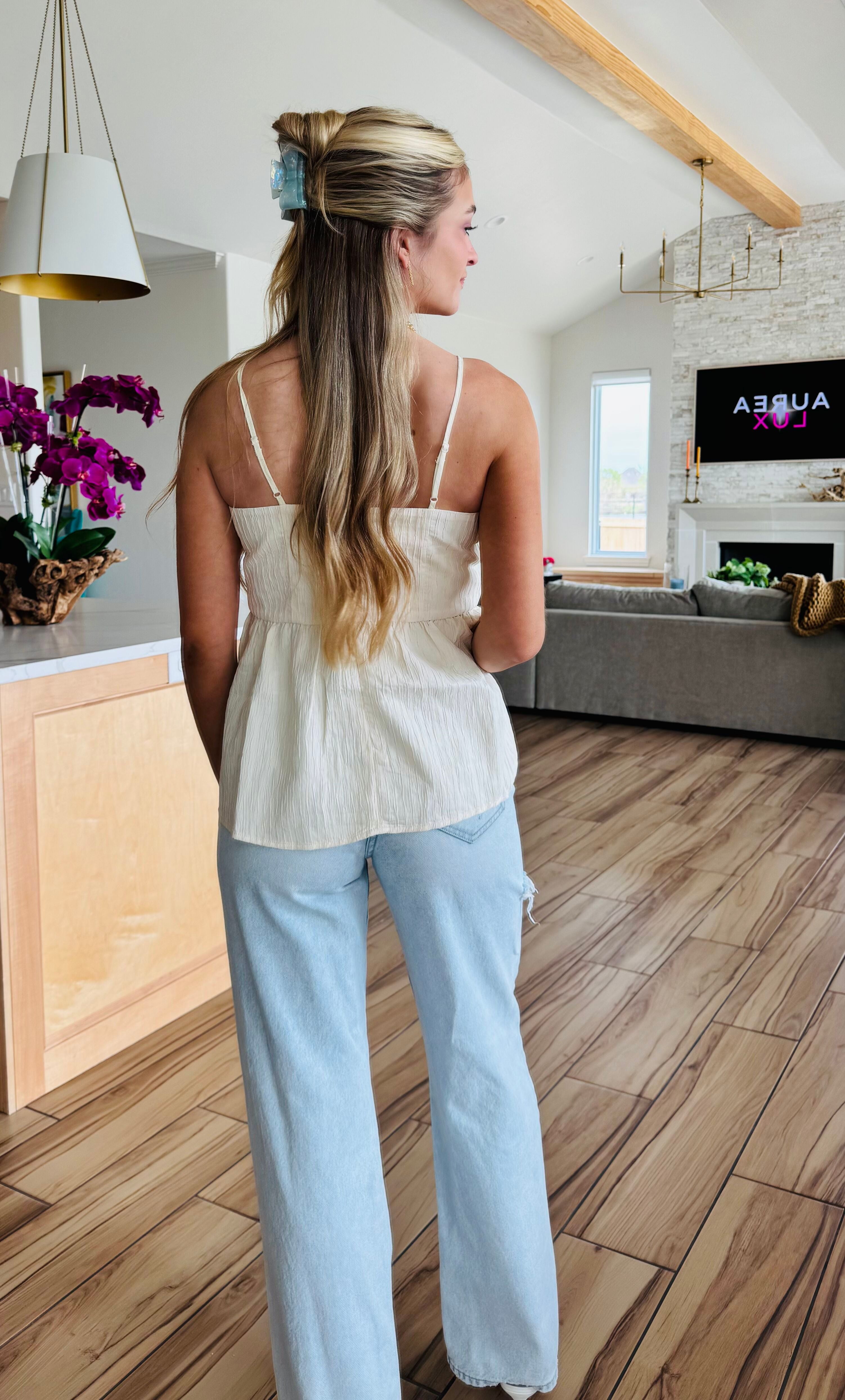 Model wearing ECRU BABYDOLL TEXTURED BOW TOP by Heyson, demonstrating its relaxed fit and versatility, perfect for dressing up or down.