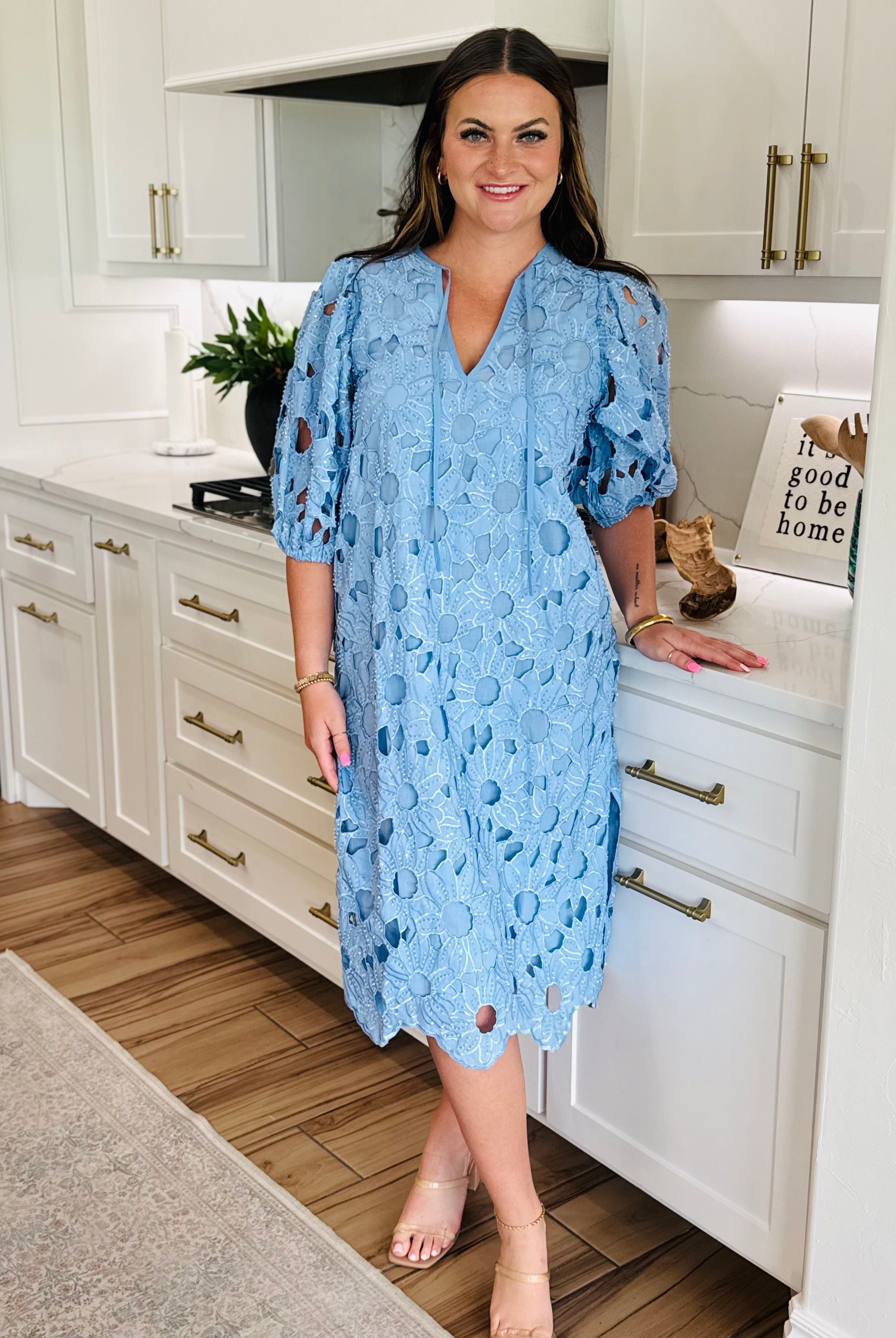 Close-up of the V-neckline and elbow-length sleeves of the Pamela Poppy Maxi Dress by Buddy Love, showcasing elegant soft elastic cuffs.