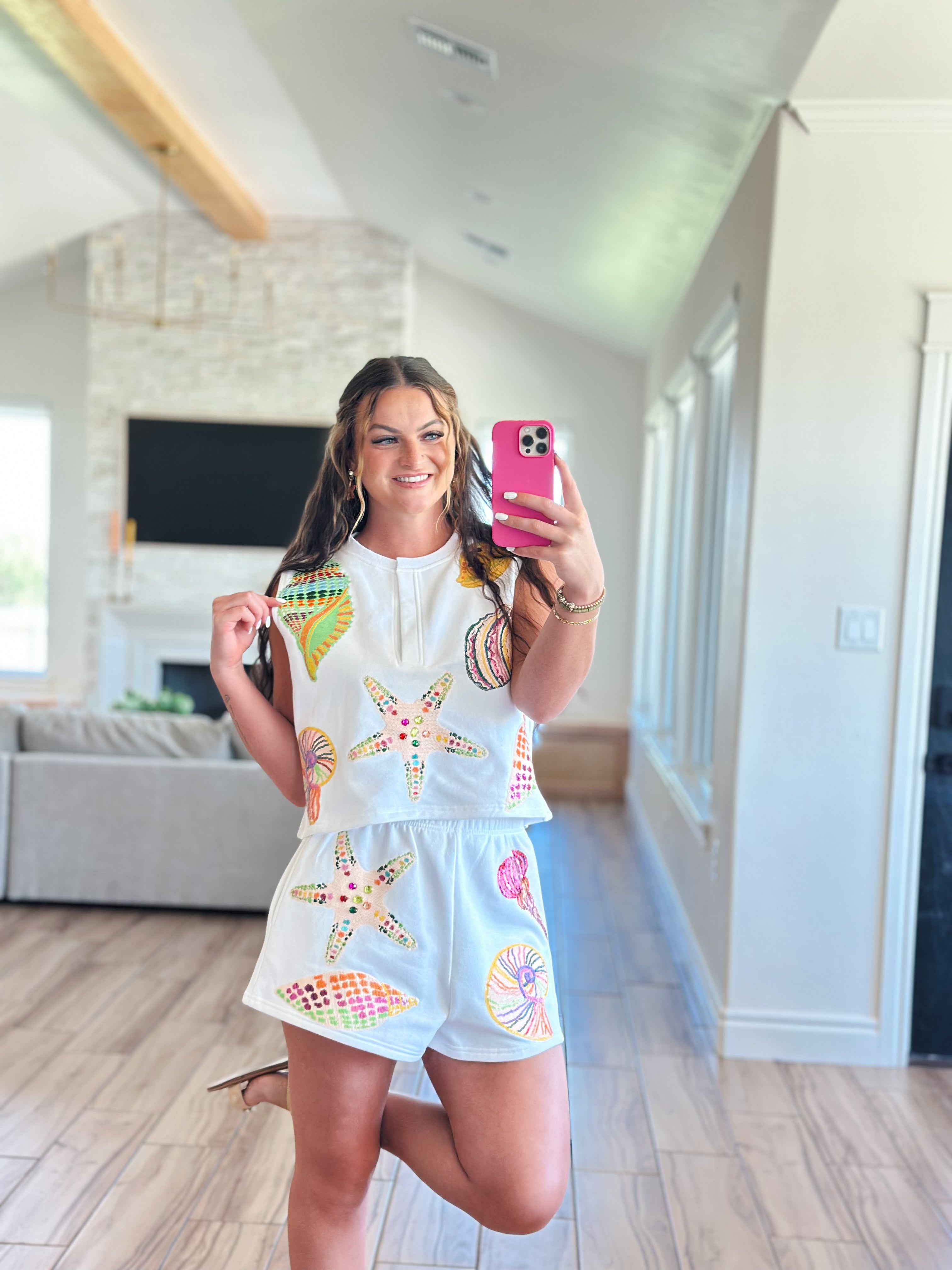 Relaxed fit Queen of Sparkles White Multi Shell Tank made from lightweight breathable fabric, perfect for pairing with denim shorts for a beachy glam outfit.