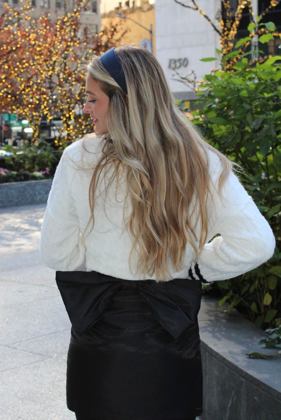 Stylish Black Bow Skirt by Aurea Lux Collective featuring a bold black color and a striking bow detail on the backside.