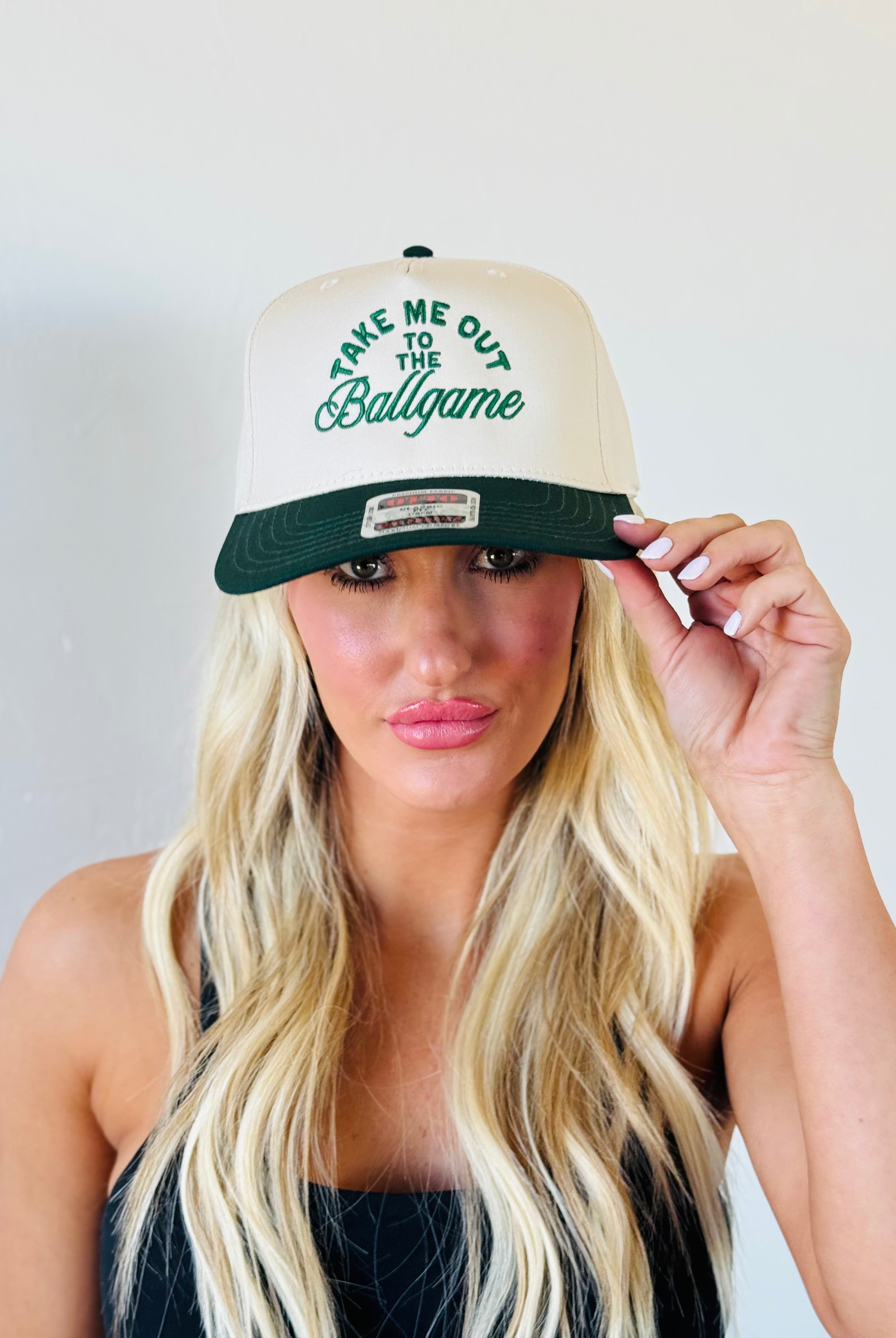 Group of friends wearing the TAKE ME OUT TO THE BALLGAME TRUCKER HAT, celebrating a fun day at the ballpark.