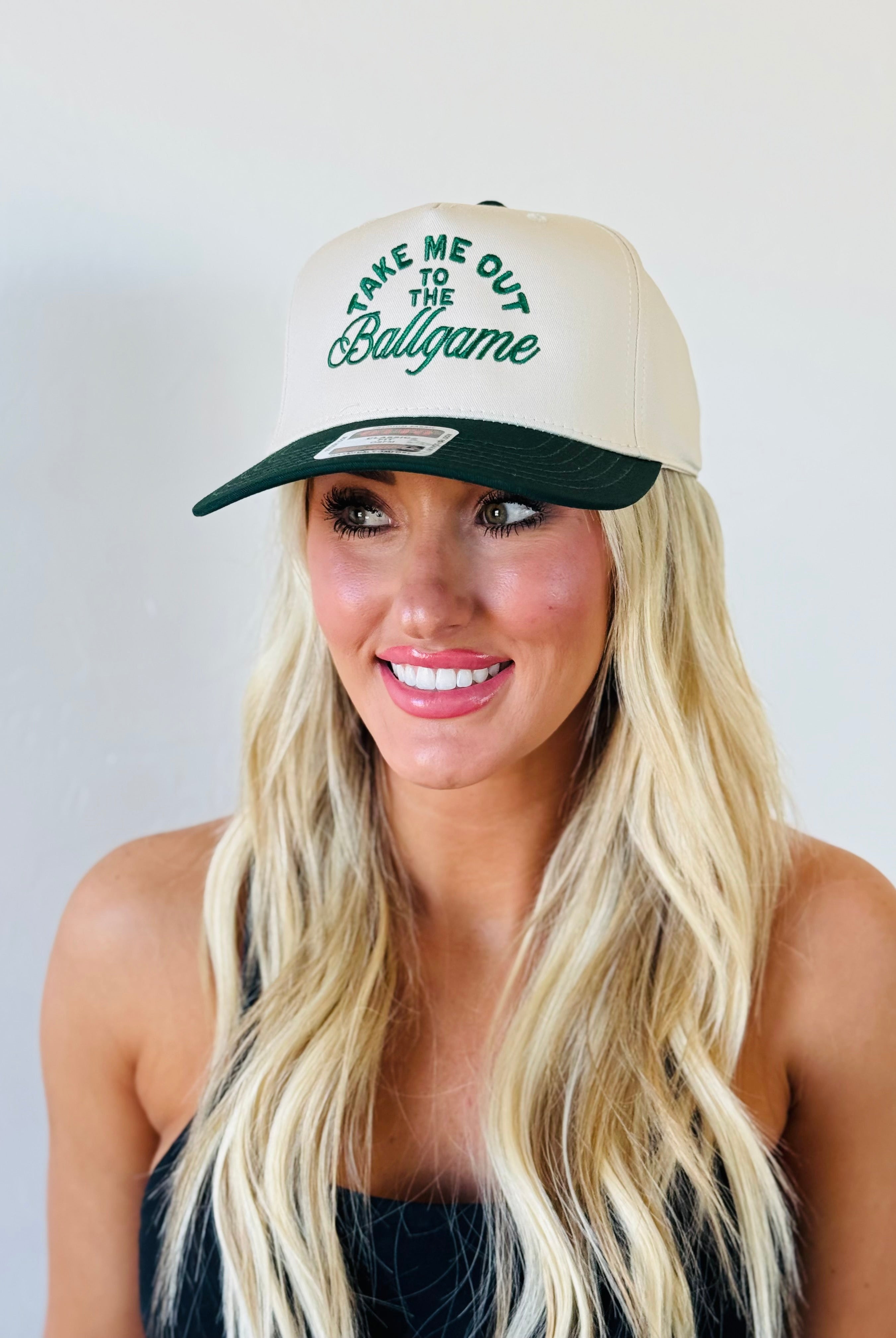 TAKE ME OUT TO THE BALLGAME TRUCKER HAT showcasing a stylish green and natural design, perfect for baseball fans.