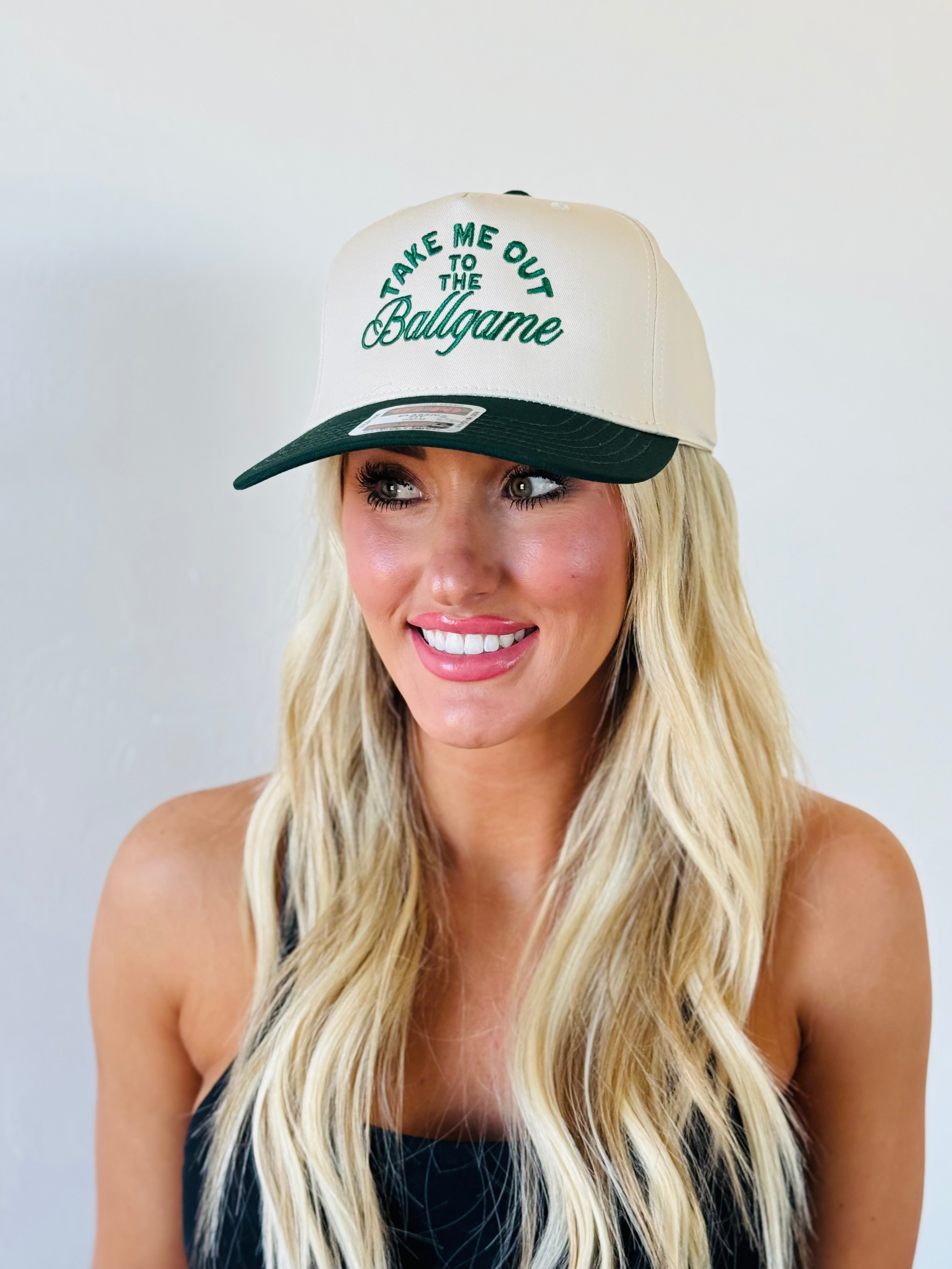 TAKE ME OUT TO THE BALLGAME TRUCKER HAT showcasing a stylish green and natural design, perfect for baseball fans.