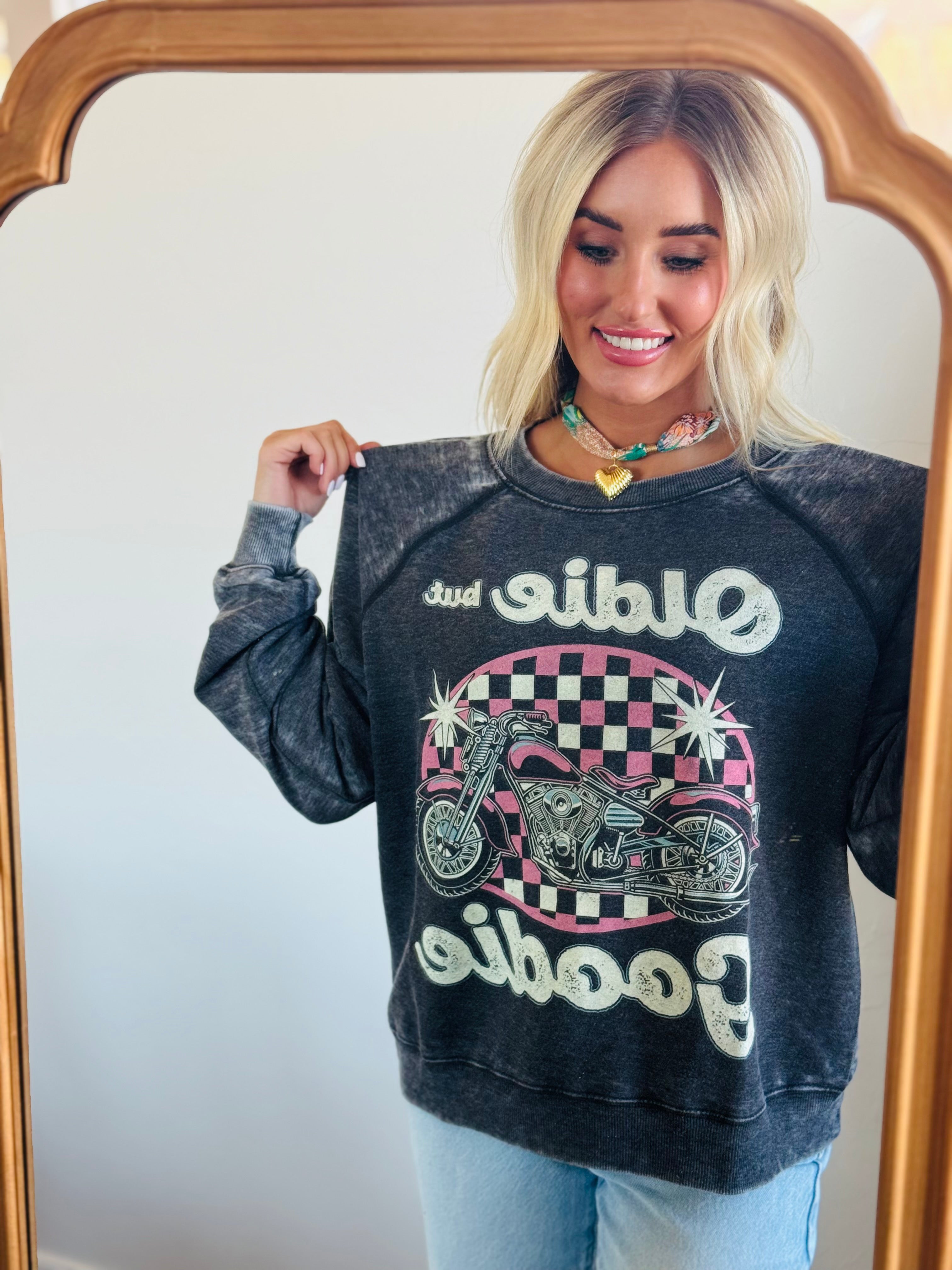 Lifestyle image featuring the 'OLDIE BUT GOODIE' sweatshirt by Recycled Karma, perfect for retro fashion lovers.