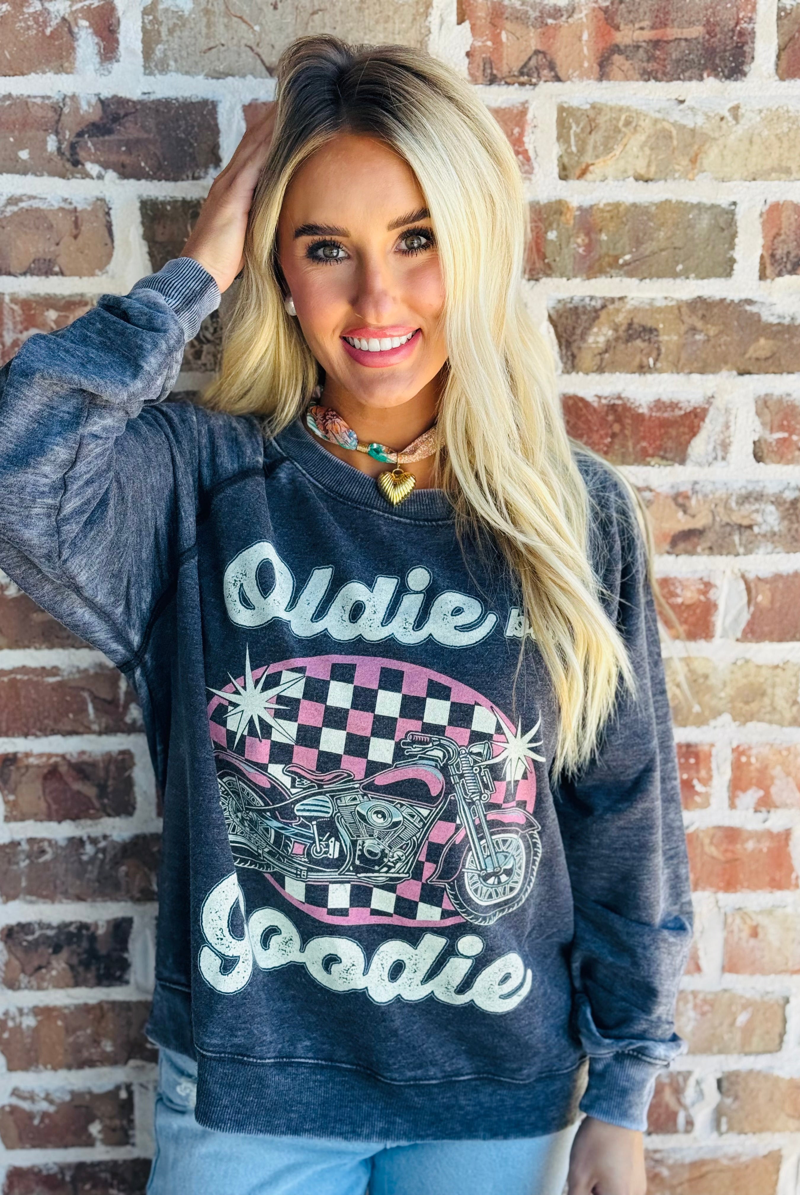Close-up of the 'OLDIE BUT GOODIE' sweatshirt by Recycled Karma showcasing the vintage fabric and retro design.