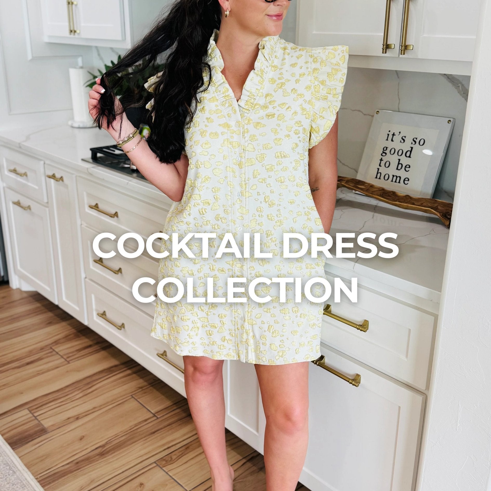 Stylish woman in a floral cocktail dress posing with a vintage phone, showcasing the elegant Cocktail Dress collection at Aurea Lux. Perfect for weddings and special events.