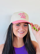 ACTUALLY IT IS ALL FUN & GAMES TRUCKER HAT in pink and natural colors, showcasing its embroidered design perfect for adding a playful touch to any outfit.
