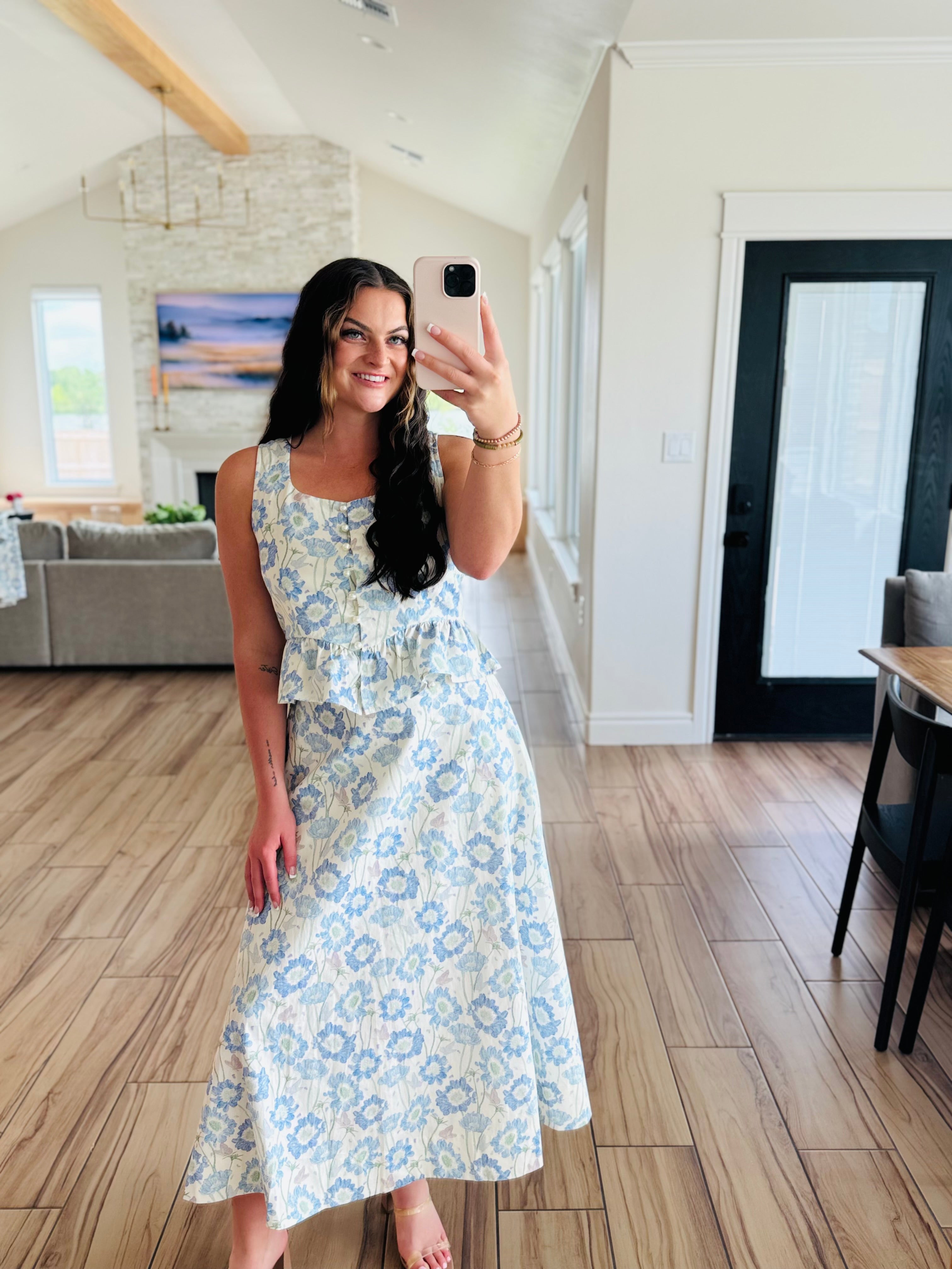 Woman wearing the ENTRO Southern Belle Blue Floral Maxi Skirt complemented with strappy sandals, ideal for brunch or casual outings.