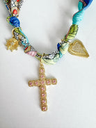 PARIS SCARF NECKLACE showcasing vibrant colors and three beautiful pendants including a pink CZ cross, gold heart, and star, perfect for stylish accessorizing.