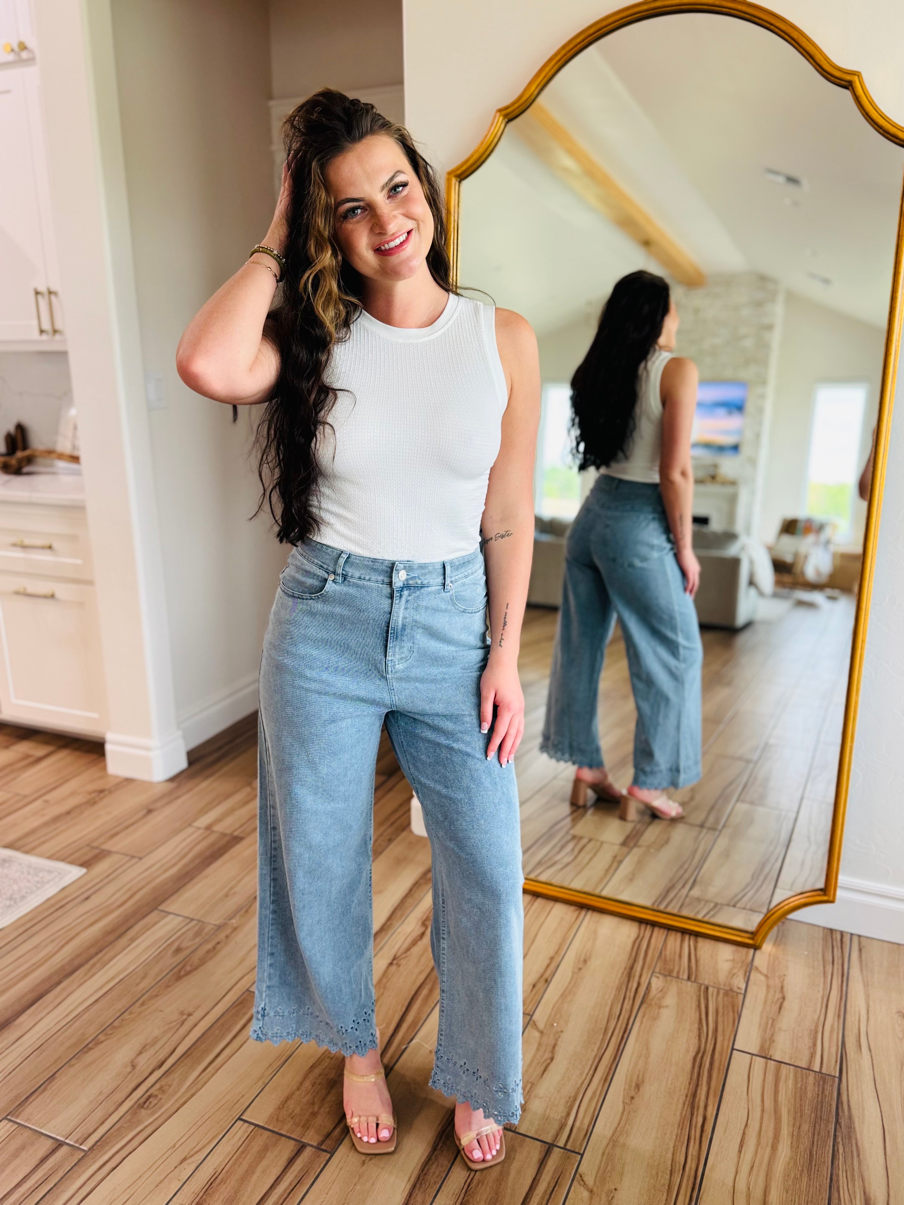 Light wash Bluebell Scallop Denim Jeans by ENTRO featuring a delicate scalloped hem, perfect for a feminine and laid-back summer style.
