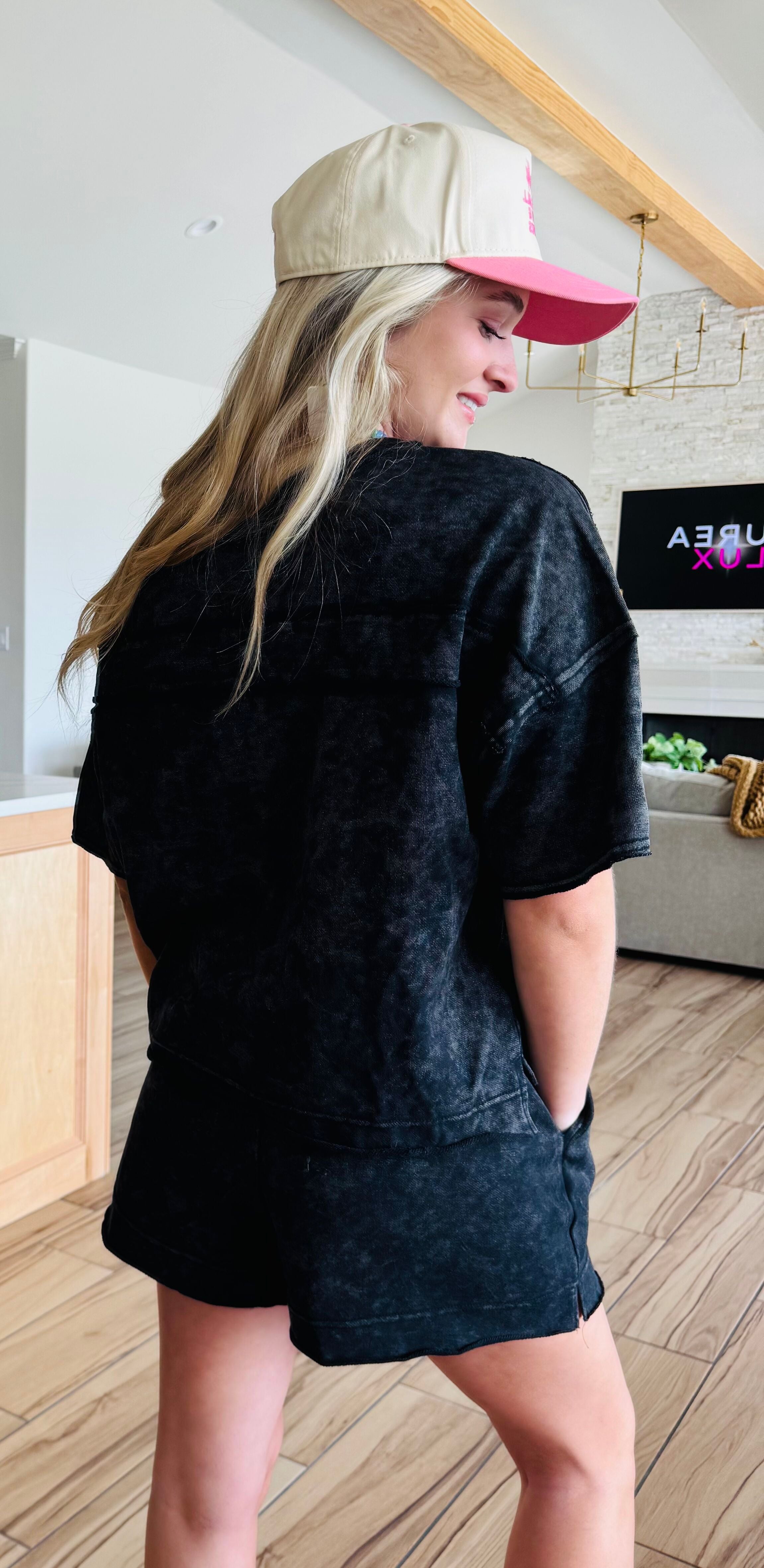 Black Mineral Washed Short Set by Very J, featuring a comfy oversized short sleeve top with a patch pocket and stylish side slit shorts with drawstring, perfect for lounging or casual outings.