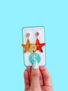 Whimsical ACRYLIC STARFISH DROP EARRINGS in vibrant colors, perfect for beach vacations and adding a playful touch to summer outfits.