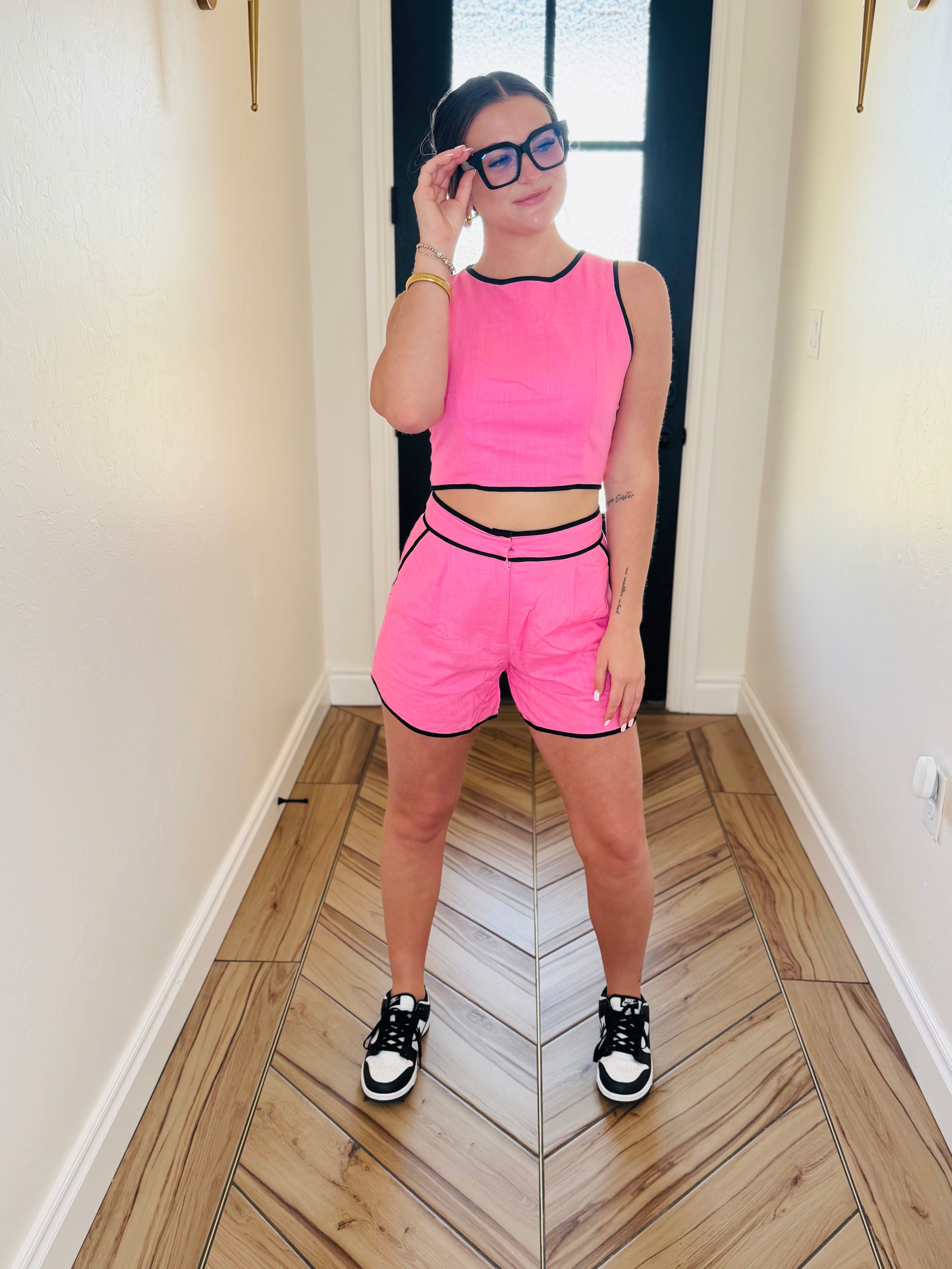 Model wearing the Barbie Pink and Black Matching Short Set featuring classy shorts with a short inseam, ideal for a fashionable and comfortable look.