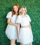 Cutie English Daisy White Floral Top and Skirt Set features a puffed sleeve cropped top with a smocked back and a high-waisted flowy skirt, perfect for brides and graduations.
