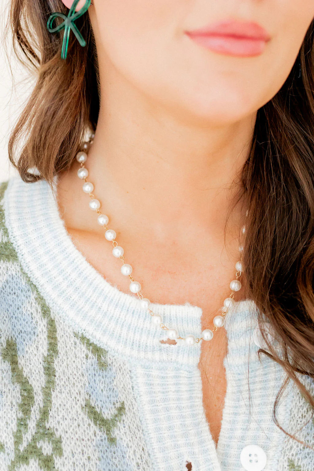 Elegant close-up of the Logan Pearl Necklace by Linny Co, showcasing the beautiful pearl pendant on a durable gold chain, ideal for layering with other jewelry or as a classy gift.