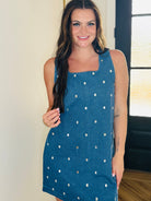 Model wearing the sleeveless denim dress with clear jewels by Entro, perfect for any occasion.