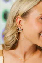 Nina Bow Hoops - stylish CZ bow-shaped earrings, perfect for adding a playful touch to any outfit.