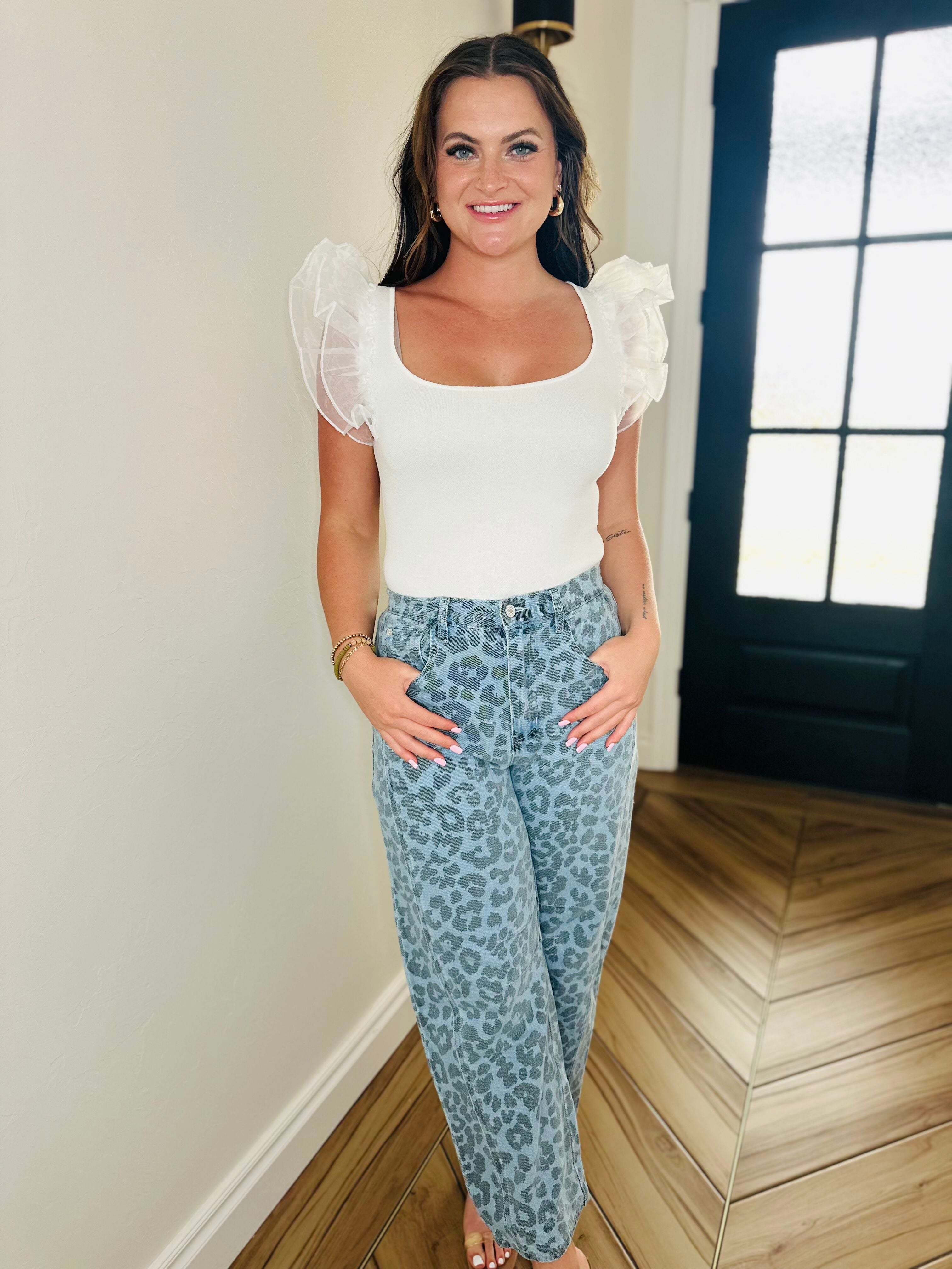 BLUE LEOPARD DENIM JEANS showcasing the bold leopard print design, perfect for adding a fierce touch to your wardrobe.
