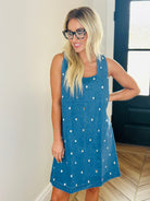 Sleeveless denim dress with clear jewels, showcasing an elegant design with a back zipper for a chic look. Perfect for any occasion, this stylish dress by Entro combines sophistication and fun.