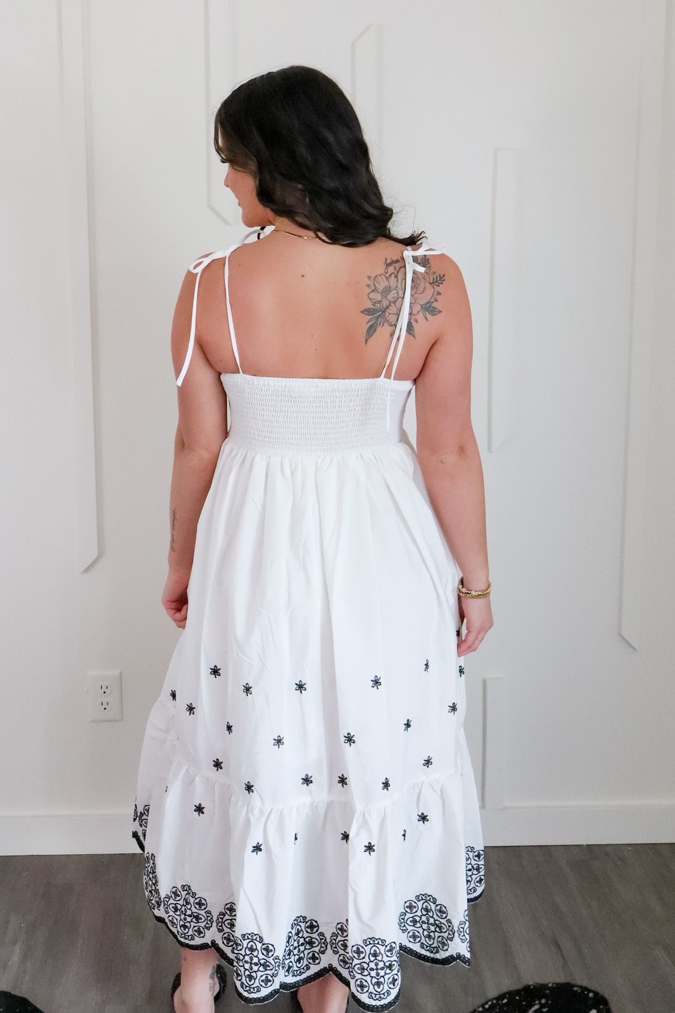 White and Black Embroidered Maxi by Entro showcasing intricate black embroidery and adjustable tie straps, perfect for beach outings and casual wear.