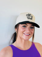ALL IS WELL EMBROIDERED TRUCKER HAT showcasing bold black embroidery against a natural color background, perfect for outdoor style.