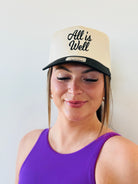 ALL IS WELL EMBROIDERED TRUCKER HAT featuring elegant black embroidery on a natural color background, perfect for stylish comfort in any outfit.