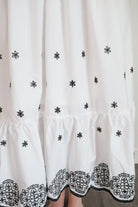 Model wearing the White and Black Embroidered Maxi by Entro, featuring a flowy design and smocked back for extra comfort and style.
