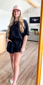 Elegant black mineral washed short set by Very J featuring a comfy oversized top with a patch pocket and stylish side slit shorts, perfect for lounging or errands.