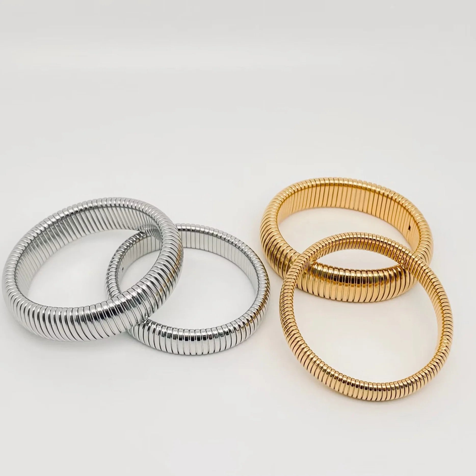 Elegant Elastic Gold Plated Bangle - 10 mm from Aurea Lux Collective, showcasing its stylish design and luxurious gold finish.