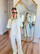 ENTRO CREAM PANT SET featuring a stylish lime green stripe design and comfortable elastic waist pants for an effortless on-the-go look.