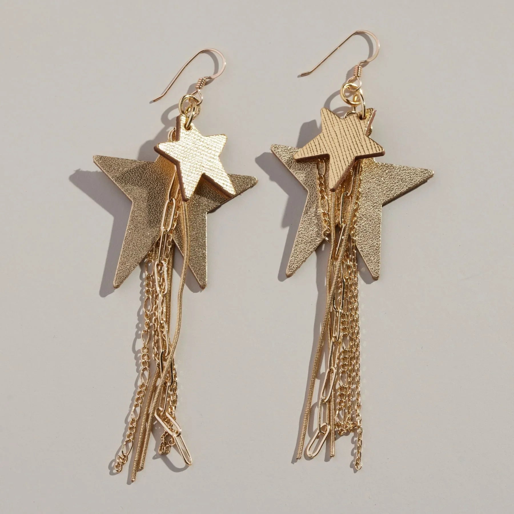 GOLD SATIN ZEPPELIN EARRINGS BY NICKEL & SUEDE showcasing a unique silhouette made from premium Italian leathers, ideal for making a bold fashion statement.