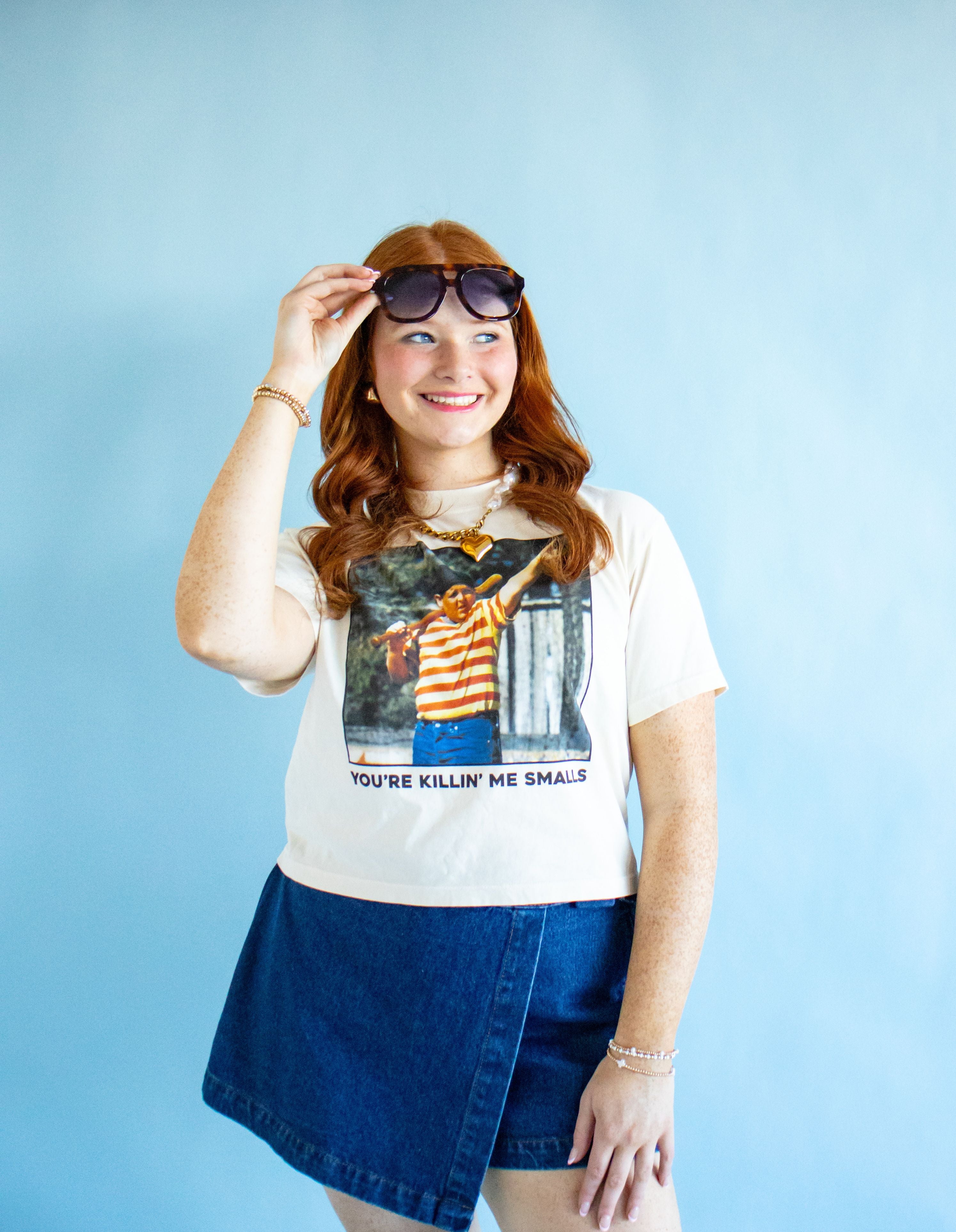 Close-up of YOU'RE KILLING ME SMALLS CROP TEE, highlighting the quality cotton fabric and vibrant print, perfect for a sporty chic outfit.
