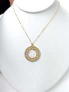 Close-up of the PEARL MOTHER OF MARY NECKLACE showcasing the intricate rhinestone details surrounding the pearl circle, a must-have accessory for a touch of sparkle.