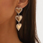 Layla - Gold Heart Earrings styled on a model, demonstrating their lightweight feel and elegant look for sensitive ears.
